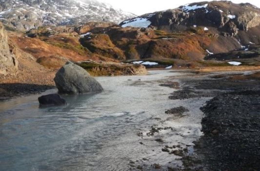 Photograph showing Brucejack Creek below Brucejack Lake. The creek is approximately 3 meters wide in the photo. The photo was taken looking upstream.